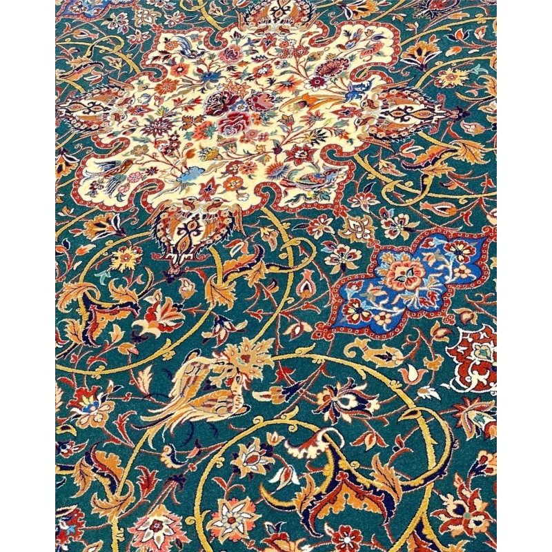 Handmade emerald green Seirafian rug with intricate floral and vine patterns.