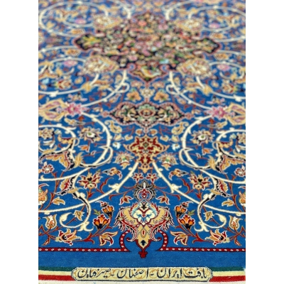 Luxurious Seirafian rug with a blend of silk and wool on a vibrant blue base.