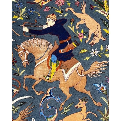 Isfahan rug with intricate natural dye motifs depicting a traditional hunting theme.