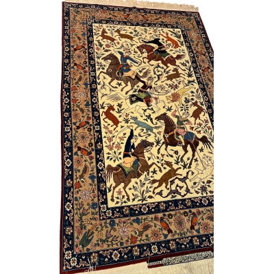 Detailed shot of a silk and wool Ahmad Seirafian rug, featuring hunting scene motifs and natural-dyed colors.