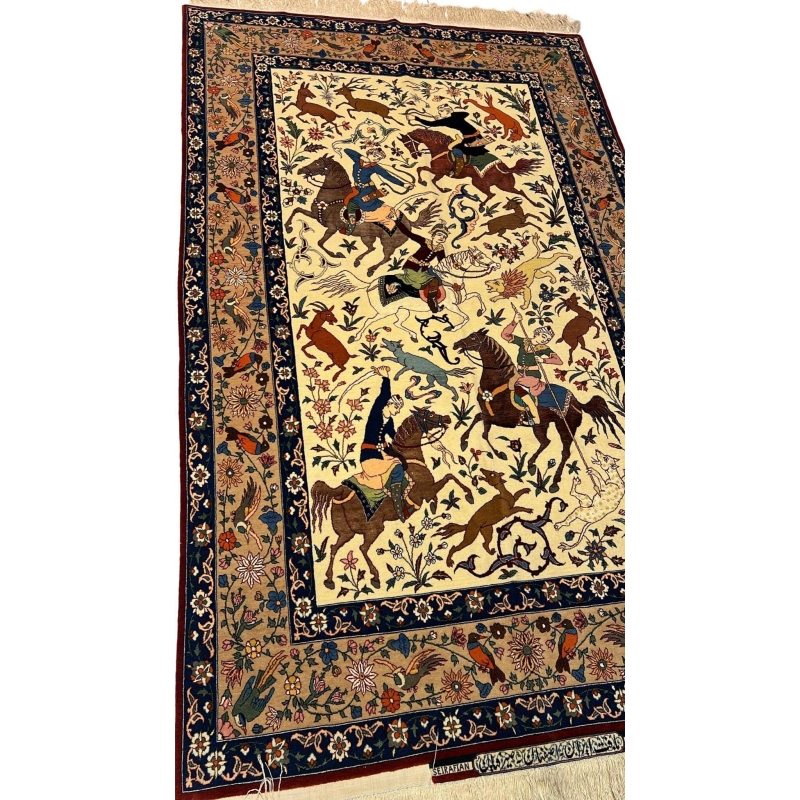 Detailed shot of a silk and wool Ahmad Seirafian rug, featuring hunting scene motifs and natural-dyed colors.