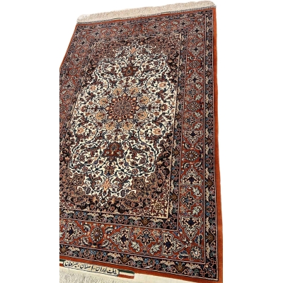 "Close-up of a hand-knotted Master Bagher Seirafian collectible rug, showcasing Persian craftsmanship with natural dyes in a floral pattern."