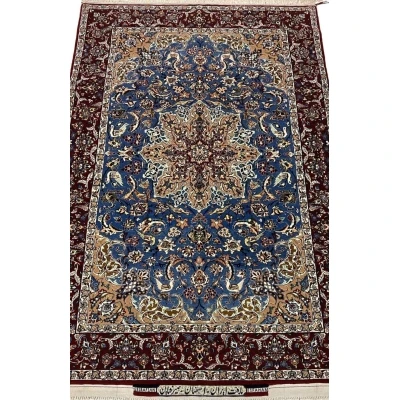 "Hand-knotted Seirafian Persian rug with intricate blue and beige floral patterns, made from wool and silk, showcasing Isfahan craftsmanship."

