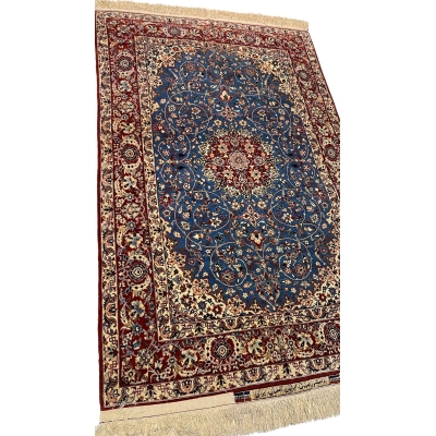"Close-up of the central medallion and floral motifs on a vintage Seirafian Persian rug by Master Sadegh Seirafian."