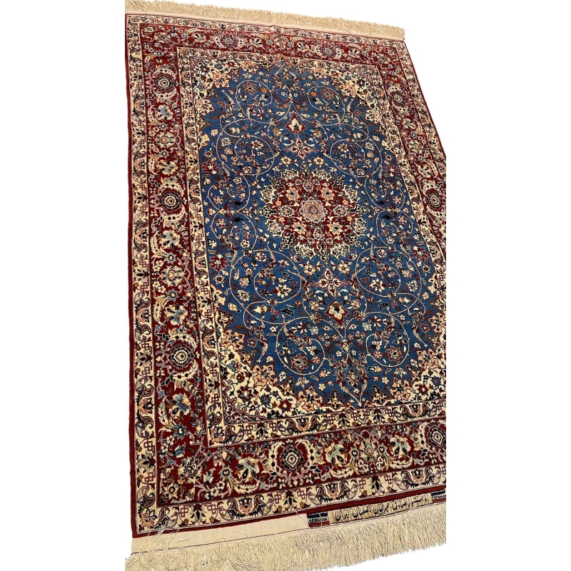 "Close-up of the central medallion and floral motifs on a vintage Seirafian Persian rug by Master Sadegh Seirafian."