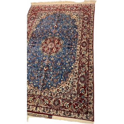"Angled view of a luxury wool and silk Persian carpet, hand-knotted by Master Sadegh Seirafian, showcasing intricate craftsmanship and 50-year-old artistry."