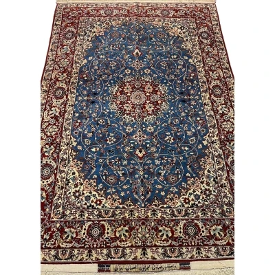 "Hand-knotted vintage Seirafian Persian rug by Master Sadegh Seirafian, featuring intricate floral patterns in blue, red, and ivory, crafted in Isfahan."
