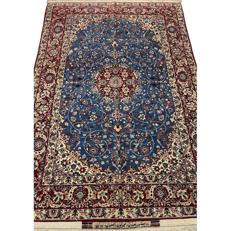 "Hand-knotted vintage Seirafian Persian rug by Master Sadegh Seirafian, featuring intricate floral patterns in blue, red, and ivory, crafted in Isfahan."