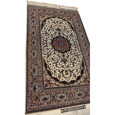 "Angled view of a mastercrafted Seirafian carpet from Isfahan, featuring luxury materials like silk and wool with detailed medallion patterns."