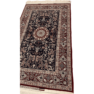 "Close-up of intricate floral and medallion patterns on a Master Bagher Seirafian Persian rug, made with silk and wool."