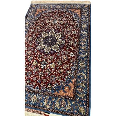 "Close-up of a Seirafian Isfahan rug with floral design, showing detailed hand-knotted craftsmanship in silk and wool."