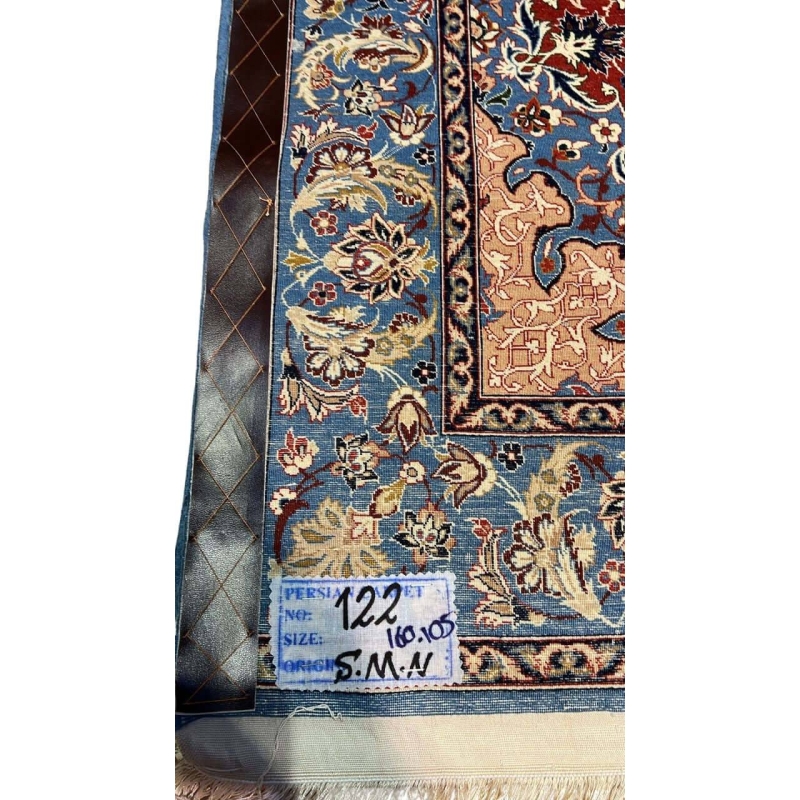 "Backside of a handwoven Seirafian silk carpet, displaying fine knot craftsmanship with silk warp and wool pile, highlighting intricate floral patterns from Isfahan."