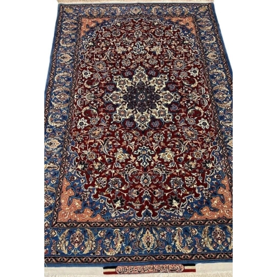 "Handwoven Seirafian silk carpet with floral design, crafted by Master Ahmad Seirafian in Isfahan, featuring intricate patterns in silk and wool."