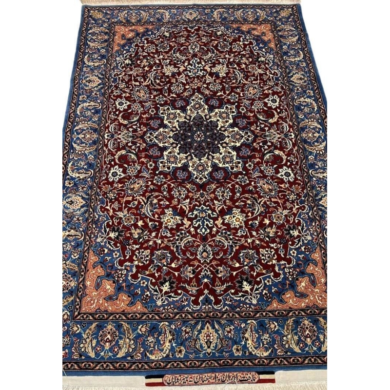 "Handwoven Seirafian silk carpet with floral design, crafted by Master Ahmad Seirafian in Isfahan, featuring intricate patterns in silk and wool."