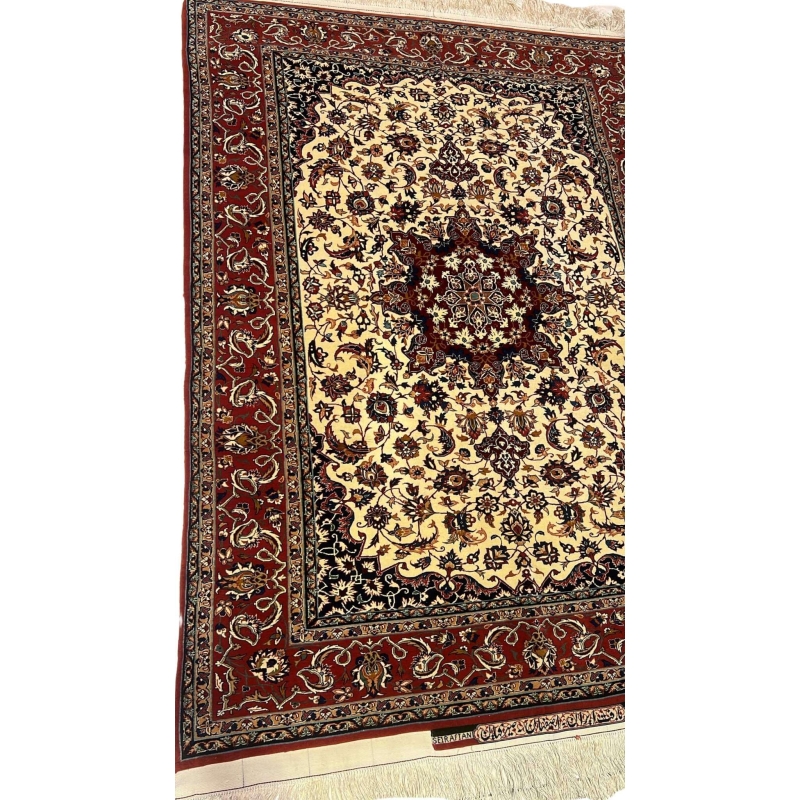 "Detailed view of the medallion design on a Seirafian Persian carpet, showcasing hand-knotted craftsmanship in red and beige tones."