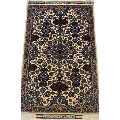 Authentic small 3x2 beige Seirafian Persian carpet, hand-knotted with silk and wool, showcasing intricate floral designs.