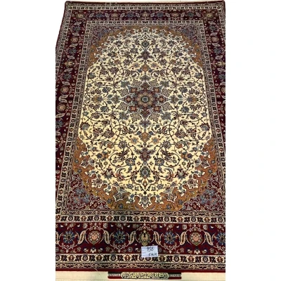 "Hand-knotted Isfahan rug by Seirafian featuring a medallion design with floral motifs."
