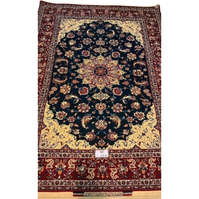 "Vintage hand-knotted Isfahan rug with a green field, yellow corners, and red borders by Ahmad Seirafian."

