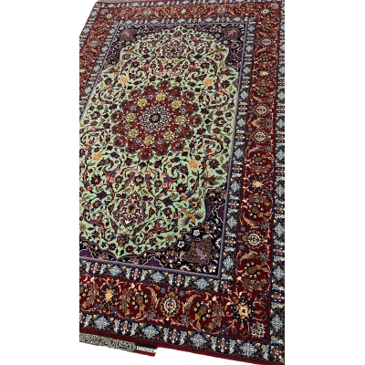 "Side view of an exclusive Seirafian wool and silk rug, showcasing detailed floral motifs and a luxurious finish."