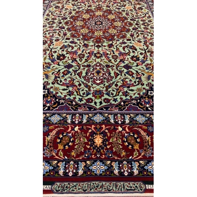 "Close-up of the Seirafian hand-knotted Persian rug with vibrant green and red tones, crafted in Isfahan."