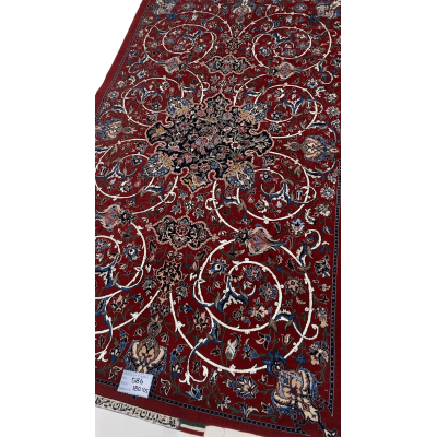 "Hand-knotted Isfahan Persian rug by renowned weaver Bagher Seirafian. Dimensions are 189 x 105 cm (approximately 6.2 x 3.4 feet) with a 5 mm thickness and a high knot density of 1,210,000 knots per square meter. The rug features a vibrant red floral design crafted from a wool and silk pile with a silk warp. This exclusive and new rug weighs 5 kg and is available for purchase."