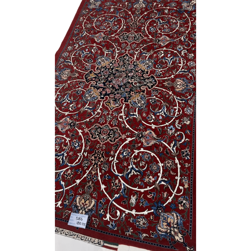 "Hand-knotted Isfahan Persian rug by renowned weaver Bagher Seirafian. Dimensions are 189 x 105 cm (approximately 6.2 x 3.4 feet) with a 5 mm thickness and a high knot density of 1,210,000 knots per square meter. The rug features a vibrant red floral design crafted from a wool and silk pile with a silk warp. This exclusive and new rug weighs 5 kg and is available for purchase."