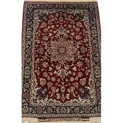 Semi-antique small Seirafian black and red Persian rug showcasing intricate floral designs and bold colors.