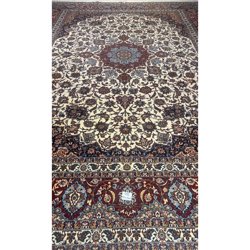 "Handwoven Isfahan rug by Master Hamid Seirafian, featuring intricate floral patterns on an ivory background."