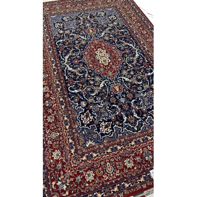 "Luxurious Persian rug featuring navy blue, red, and cream tones, crafted in Isfahan, Iran."