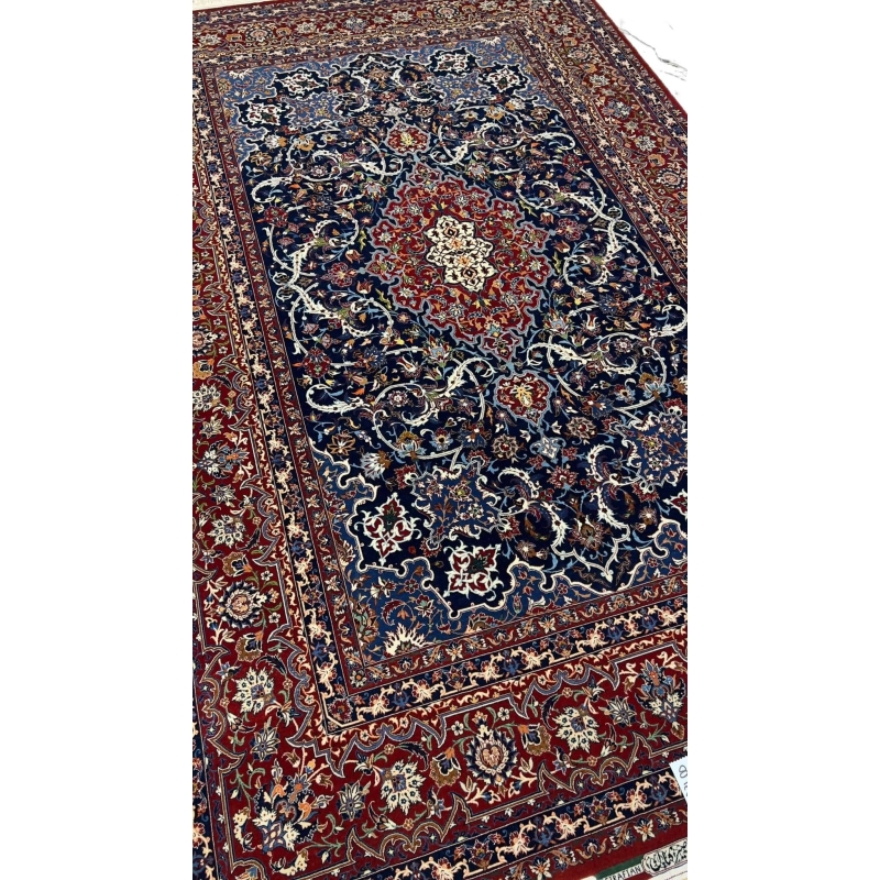 "Luxurious Persian rug featuring navy blue, red, and cream tones, crafted in Isfahan, Iran."