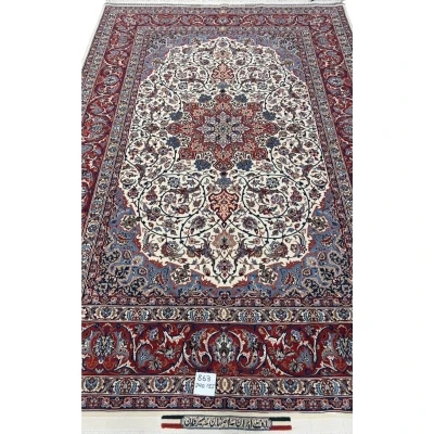 "Hand-knotted Isfahan rug with star medallion design in cream, red, and blue, crafted by Master Bagher Seirafian."
