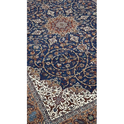 "Luxurious Persian rug showcasing a central medallion design in deep blue, ivory, and gold tones."