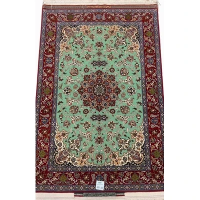 Hand-knotted Seirafian Persian rug with mint green and crimson red accents.
