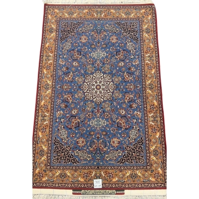 Hand-knotted Seirafian rug in blue and gold with intricate floral patterns.
