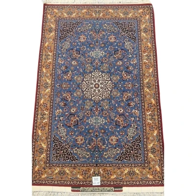 Hand-knotted Seirafian rug in blue and gold with intricate floral patterns.
