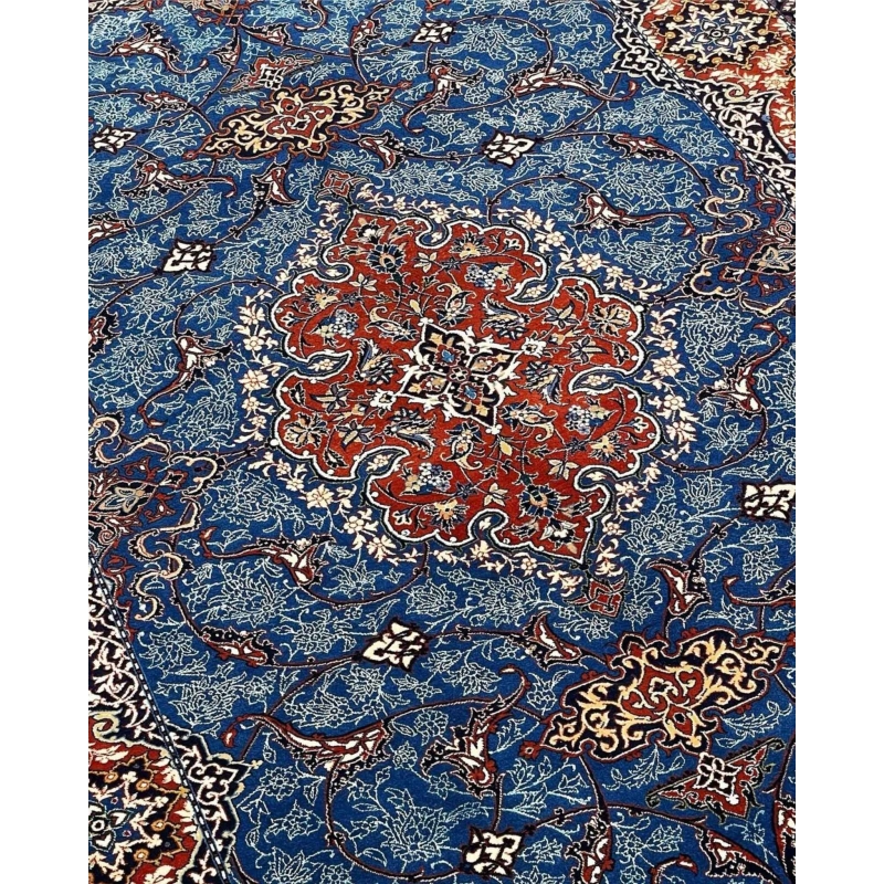 Authentic Persian carpet with rich red borders and detailed floral motifs.