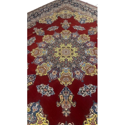 "Luxurious Persian rug showcasing intricate floral and paisley motifs in bold red, yellow, and blue hues."