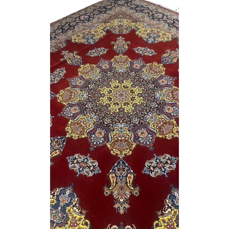 "Luxurious Persian rug showcasing intricate floral and paisley motifs in bold red, yellow, and blue hues."