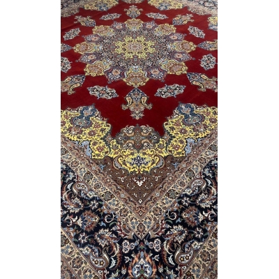 "Close-up of the vibrant yellow medallion design on a silk and wool Persian rug."