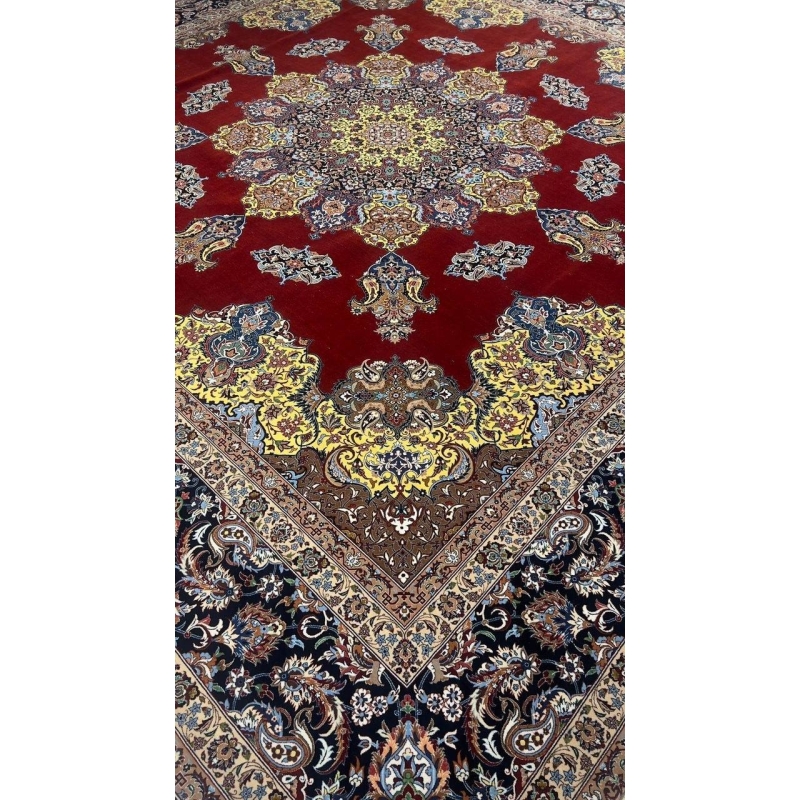 "Close-up of the vibrant yellow medallion design on a silk and wool Persian rug."