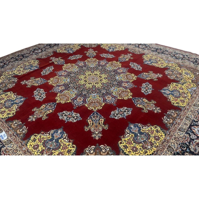 "Exquisite Isfahan rug featuring a bold crimson field, detailed yellow medallion, and intricate floral patterns."