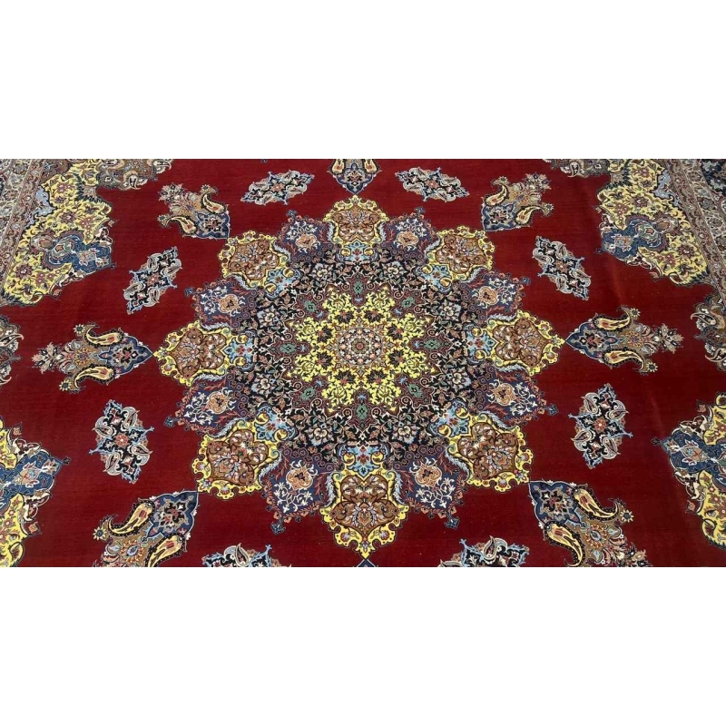 "Handwoven Persian rug by Master Bagher Seirafian, showcasing rich red, gold, and blue hues with a luxurious silk and wool blend."