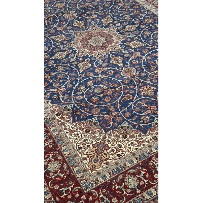 "Exquisite Persian rug featuring floral motifs and paisley patterns in rich navy, red, and ivory."