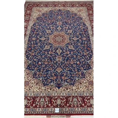 "Hand-knotted Isfahan rug by Master Bagher Seirafian with a navy blue field and red medallion."
