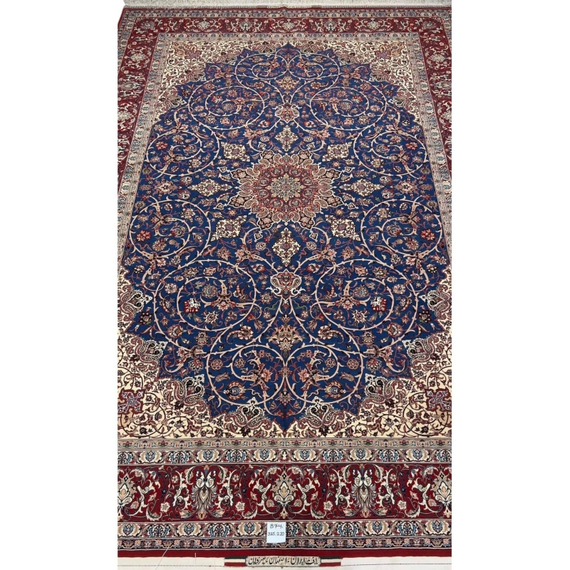 "Hand-knotted Isfahan rug by Master Bagher Seirafian with a navy blue field and red medallion."