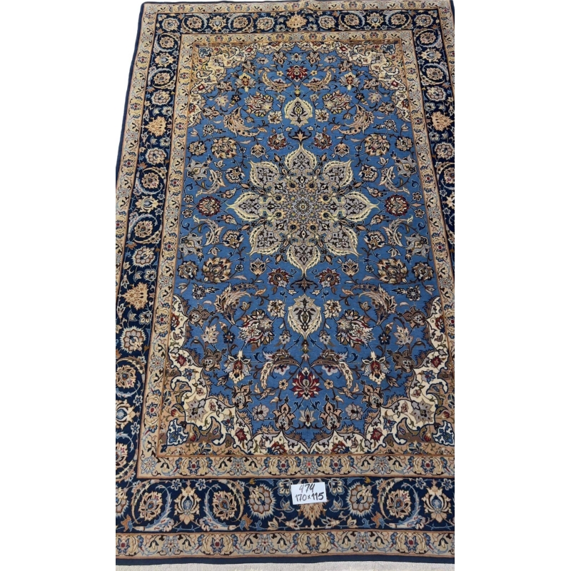 "Hand-knotted blue Persian rug from Isfahan, 170x115 cm, showcasing intricate floral and medallion designs in a wool and silk blend."
