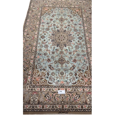 Hand-knotted Isfahan rug with a mint-green base and floral medallion.
