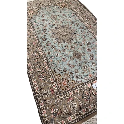 Persian rug featuring a central medallion and beige floral borders.