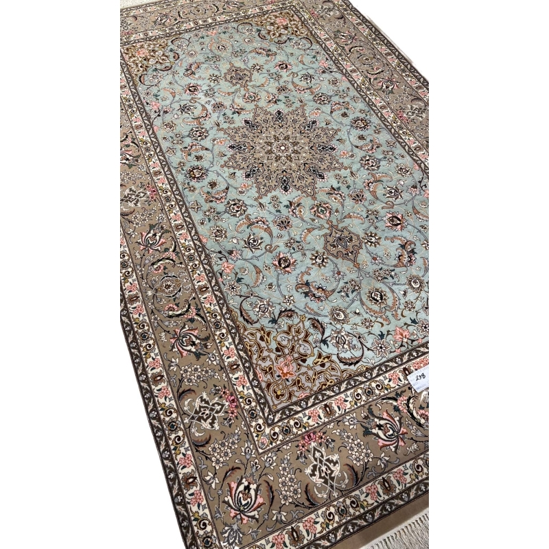 Persian rug featuring a central medallion and beige floral borders.
