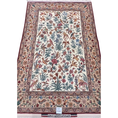 Hand-knotted Isfahan Persian rug with intricate floral and bird motifs on an ivory background, crafted with silk and wool.